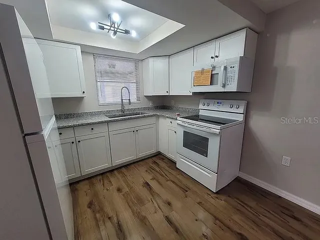 a white toilet sitting next to a bath tub