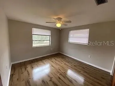 a view of a room with wooden floor and a window