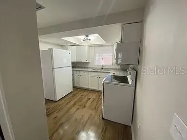 a kitchen with a sink a refrigerator and washer