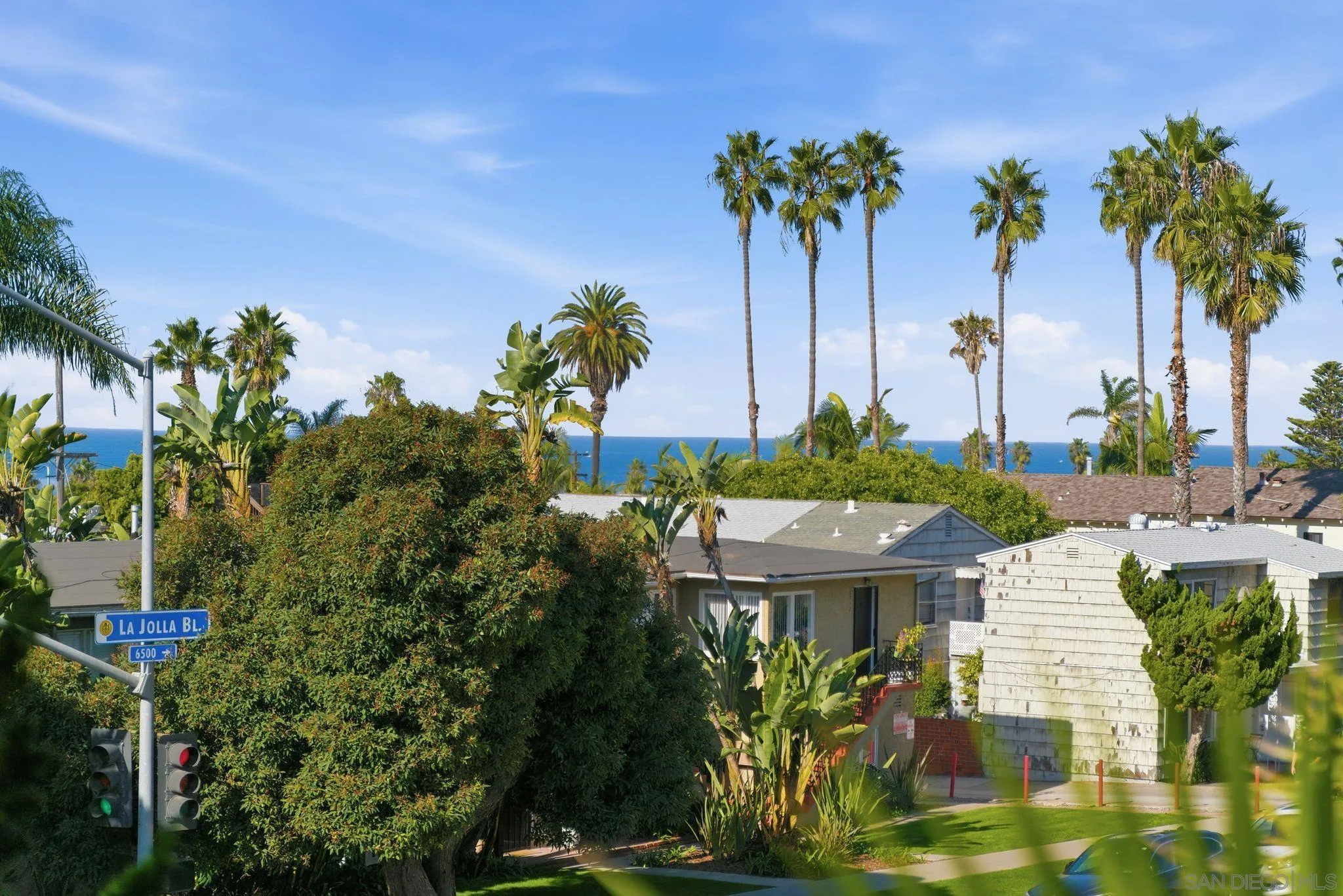 a view of a house with palm trees