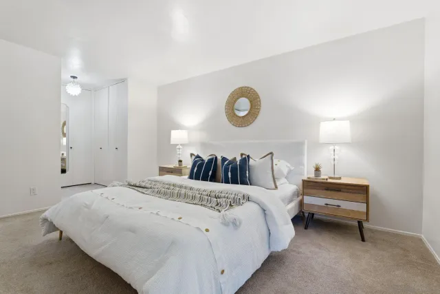 a bed room with a bed and a lamp