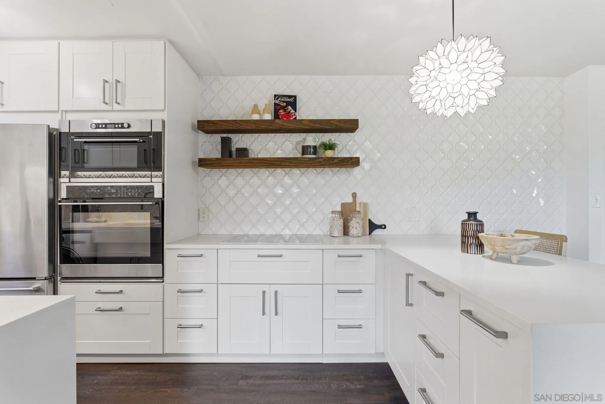 6455 La Jolla Boulevard, Unit 206 La Jolla, CA 92037 - Photo 2 of 24 a kitchen with white cabinets and sink
