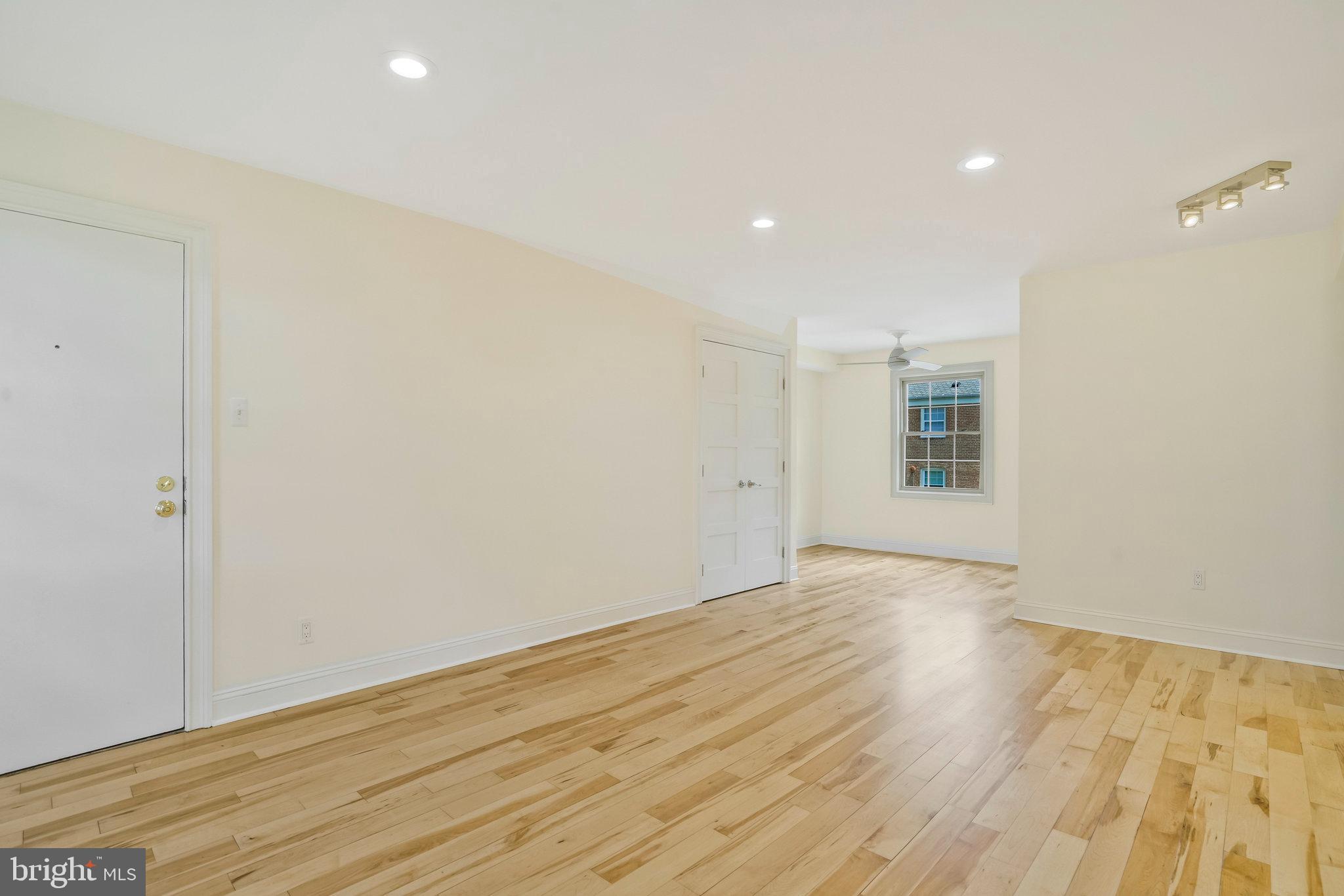 2505 Arlington Boulevard, Unit 102 Arlington, VA 22201 - Photo 11 of 26 a view of an empty room with wooden floor and a window