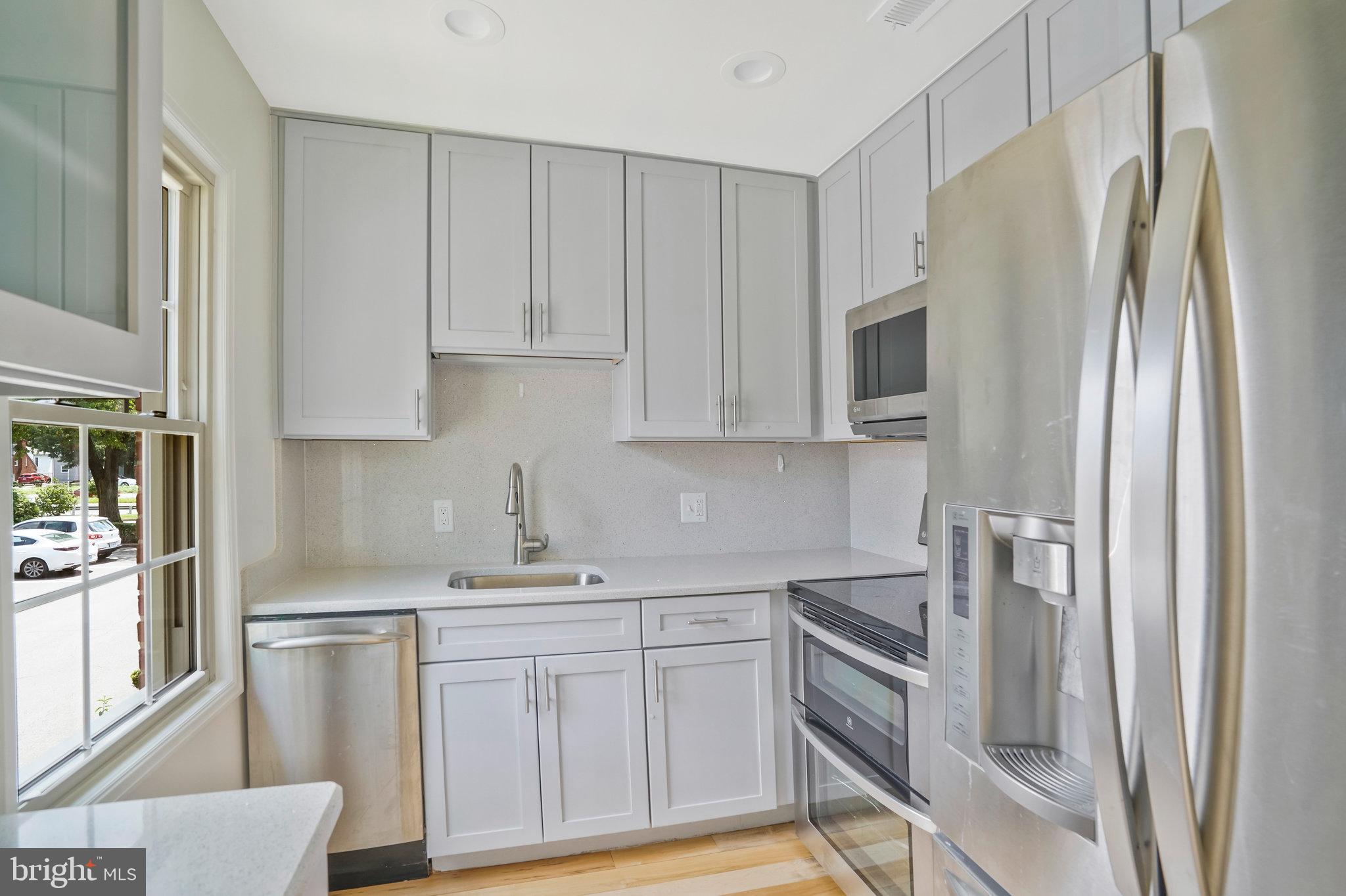 2505 Arlington Boulevard, Unit 102 Arlington, VA 22201 - Photo 16 of 26 a kitchen with stainless steel appliances a refrigerator sink and cabinets