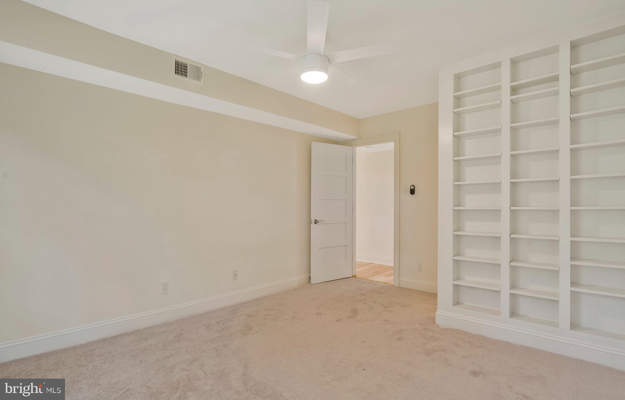 2505 Arlington Boulevard, Unit 102 Arlington, VA 22201 - Photo 19 of 26 a view of an empty room with a empty shelves