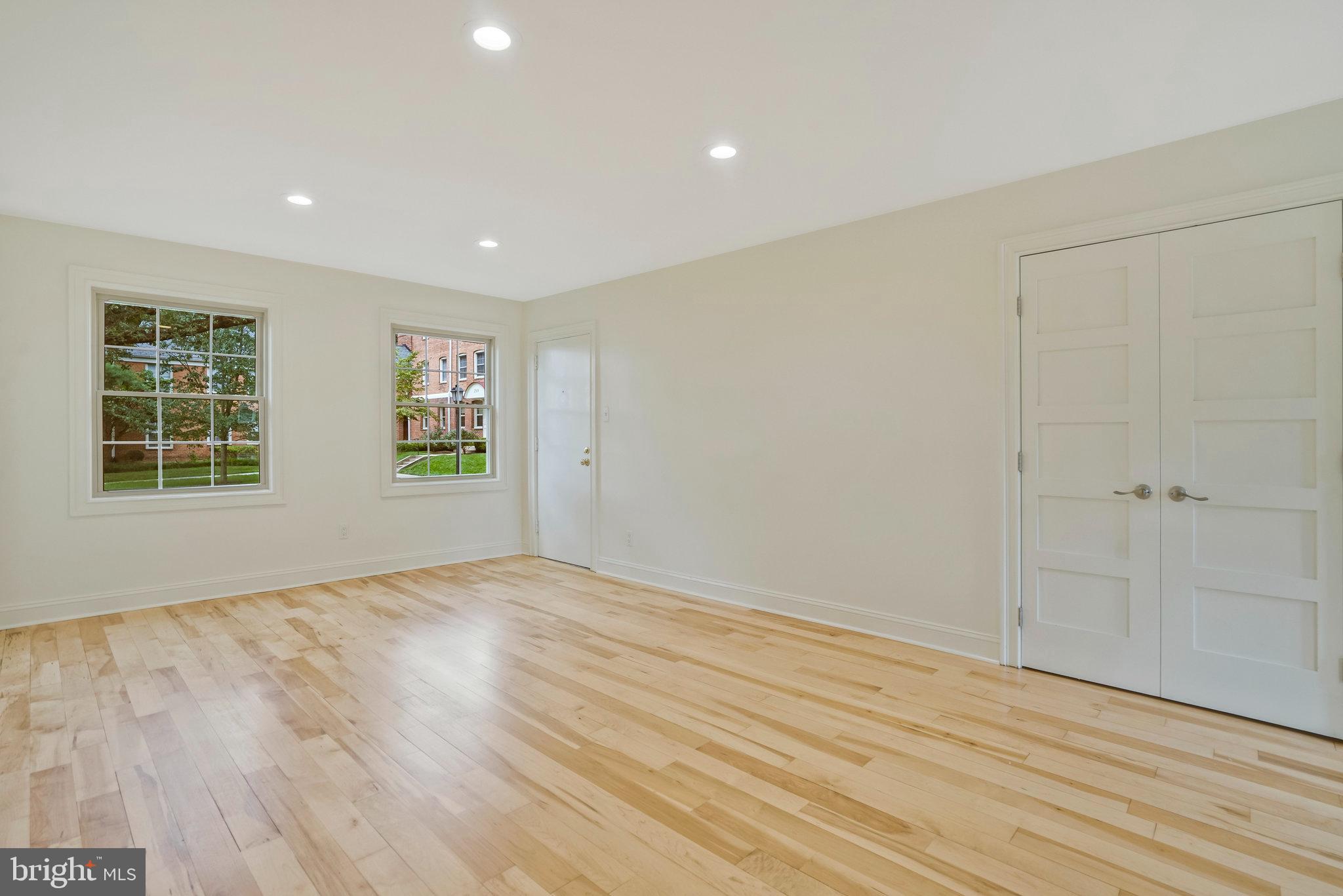 2505 Arlington Boulevard, Unit 102 Arlington, VA 22201 - Photo 8 of 26 a view of empty room with wooden floor and fan