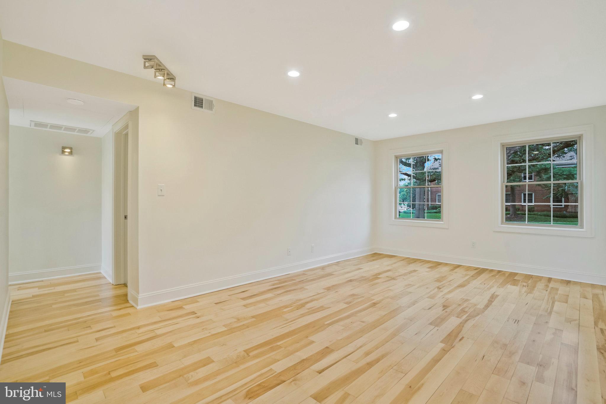 2505 Arlington Boulevard, Unit 102 Arlington, VA 22201 - Photo 9 of 26 a view of empty room with wooden floor and fan