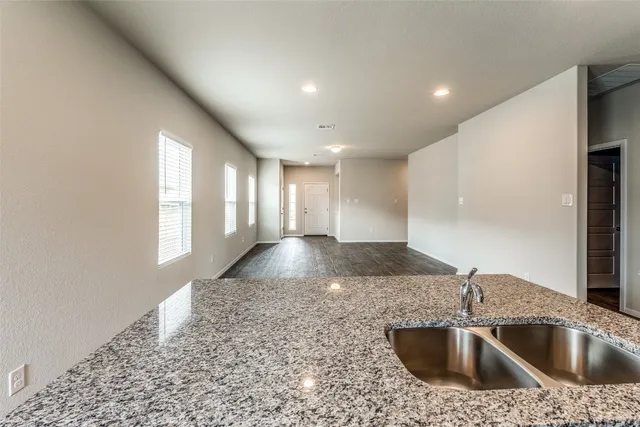 a kitchen with a sink stove and cabinets