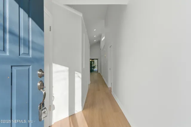 a view of hallway with wooden floor