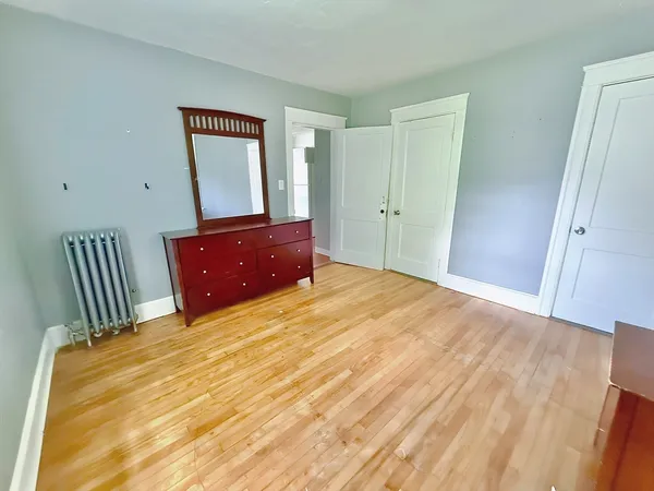 a bedroom with a bed and a dresser
