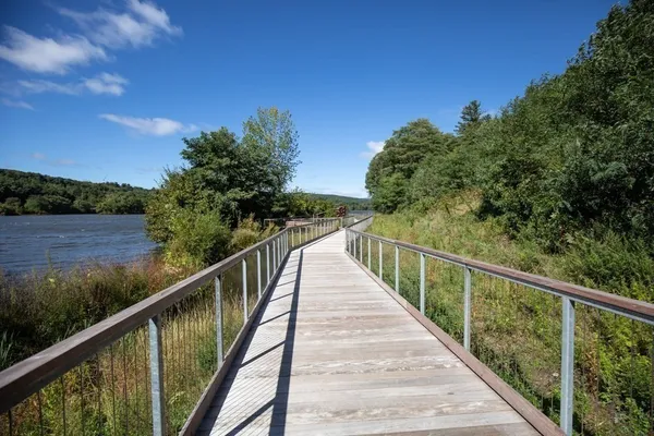 a view of a balcony with wooden floor and fence
