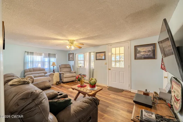 a bedroom with a bed furniture and a flat tv screen
