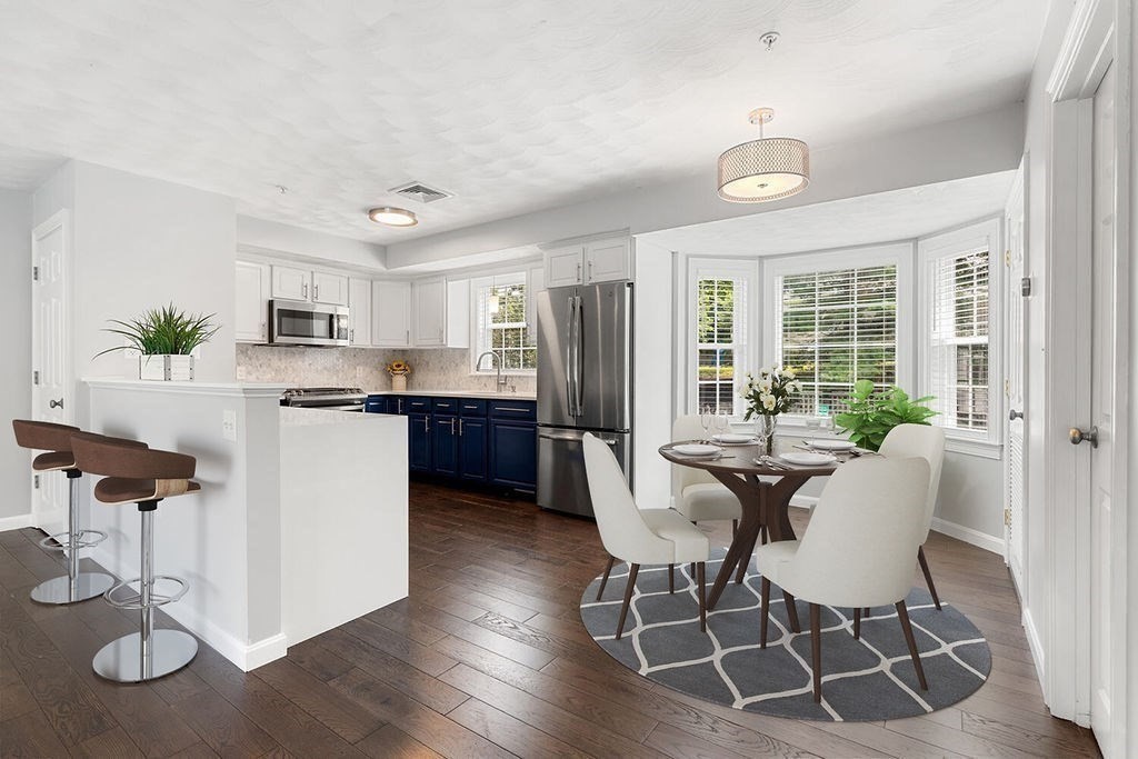 2 Ricciuti Drive, Unit 9 Quincy, MA 02169 - Photo 8 of 40 a view of a dining room with furniture window and wooden floor