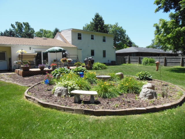 3918 Abbotsford Road Rockford, IL 61107 - Photo 25 of 25 a view of a house with backyard sitting area and garden