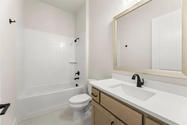 a bathroom with a sink a toilet and a bathtub