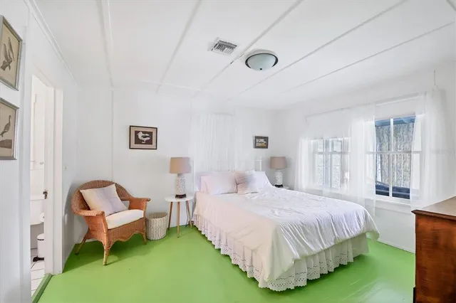 a bedroom with a bed and a couch