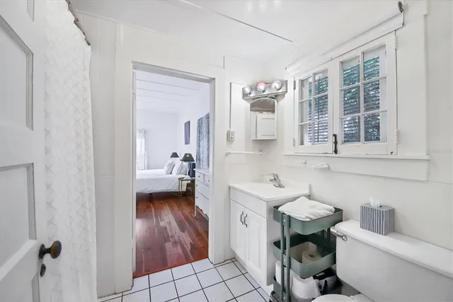 a bathroom with a sink toilet a mirror and tub