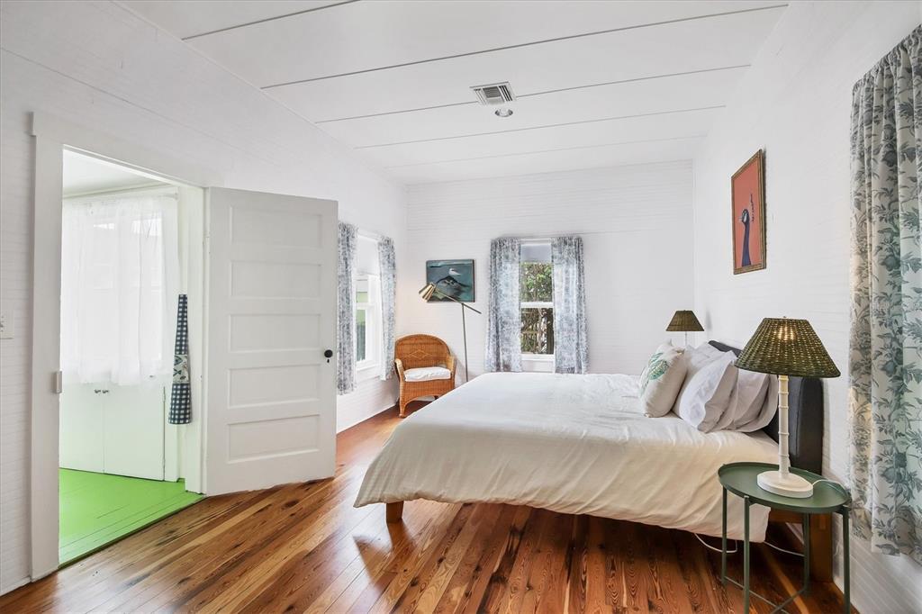 241 Gilchrist Avenue, Unit C Boca Grande, FL 33921 - Photo 13 of 23 a bedroom with a bed and wooden floor