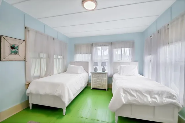 a bedroom with a bed and window