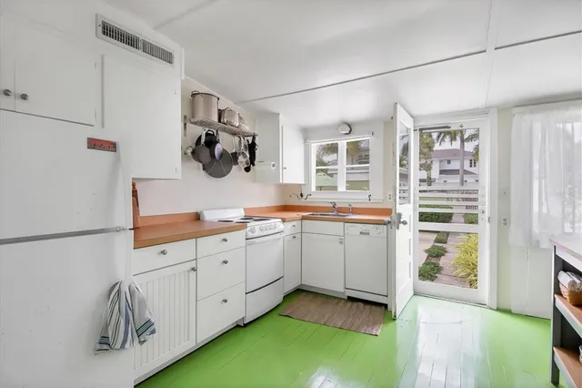 a kitchen with white cabinets and white appliances