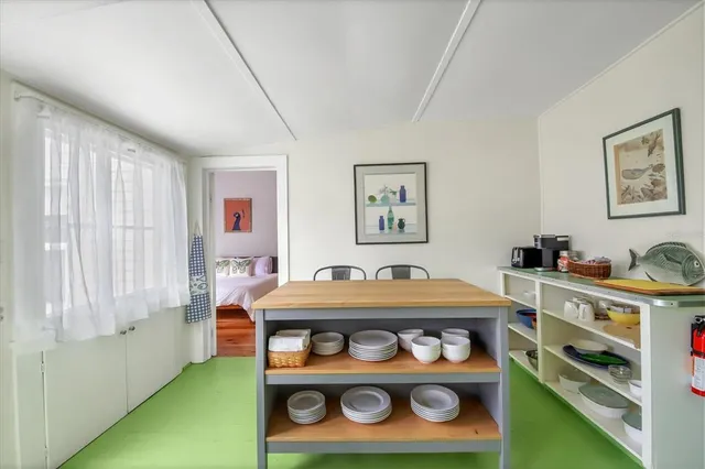 a room with stainless steel appliances lots of fruit and furniture