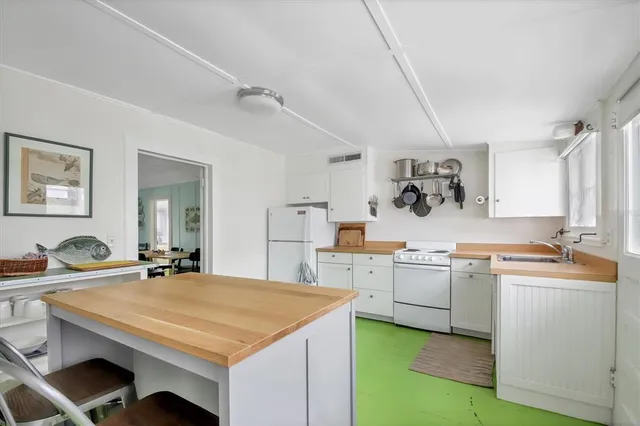 a kitchen with sink stove and cabinets