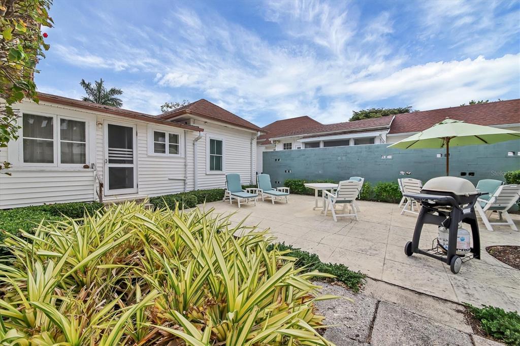 241 Gilchrist Avenue, Unit C Boca Grande, FL 33921 - Photo 22 of 23 a view of a house with pool and chairs