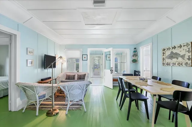 a dining room with furniture and wooden floor