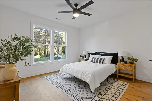 a bedroom with a bed dresser and a window