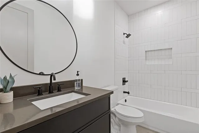 a bathroom with a sink a toilet and a mirror