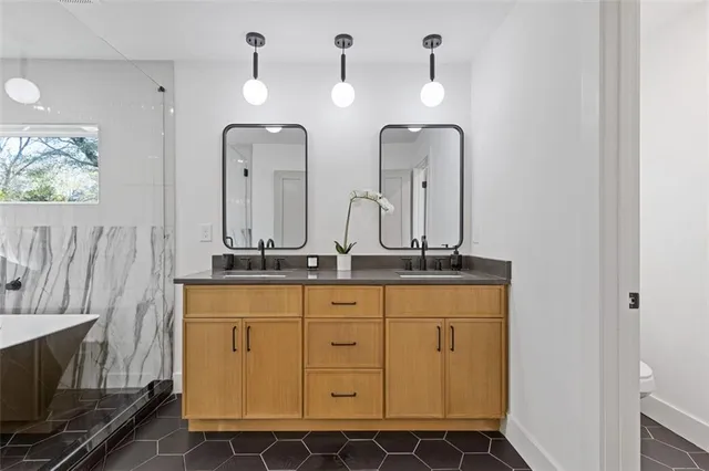 a bathroom with a double vanity sink and a mirror