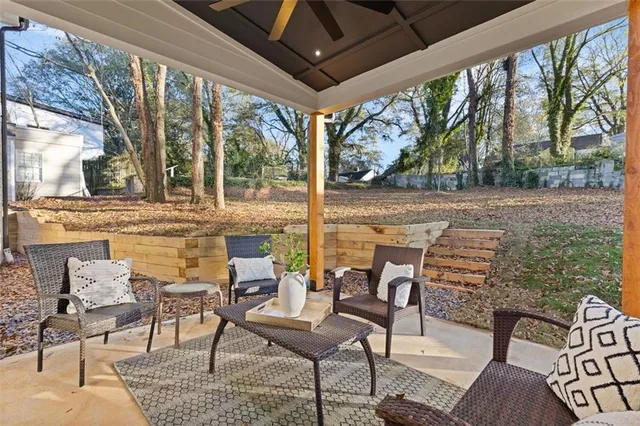 a view of two chairs and a table in the patio