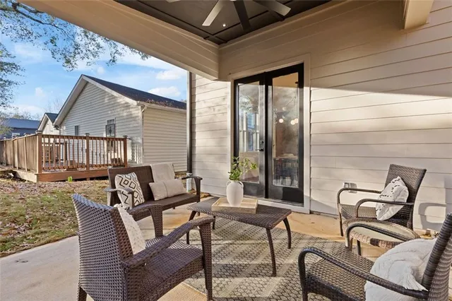 a view of a patio with glass top table and chairs