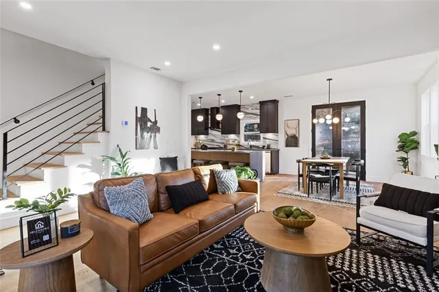 a living room with furniture and wooden floor