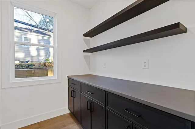 a view of storage and utility room with wooden floor