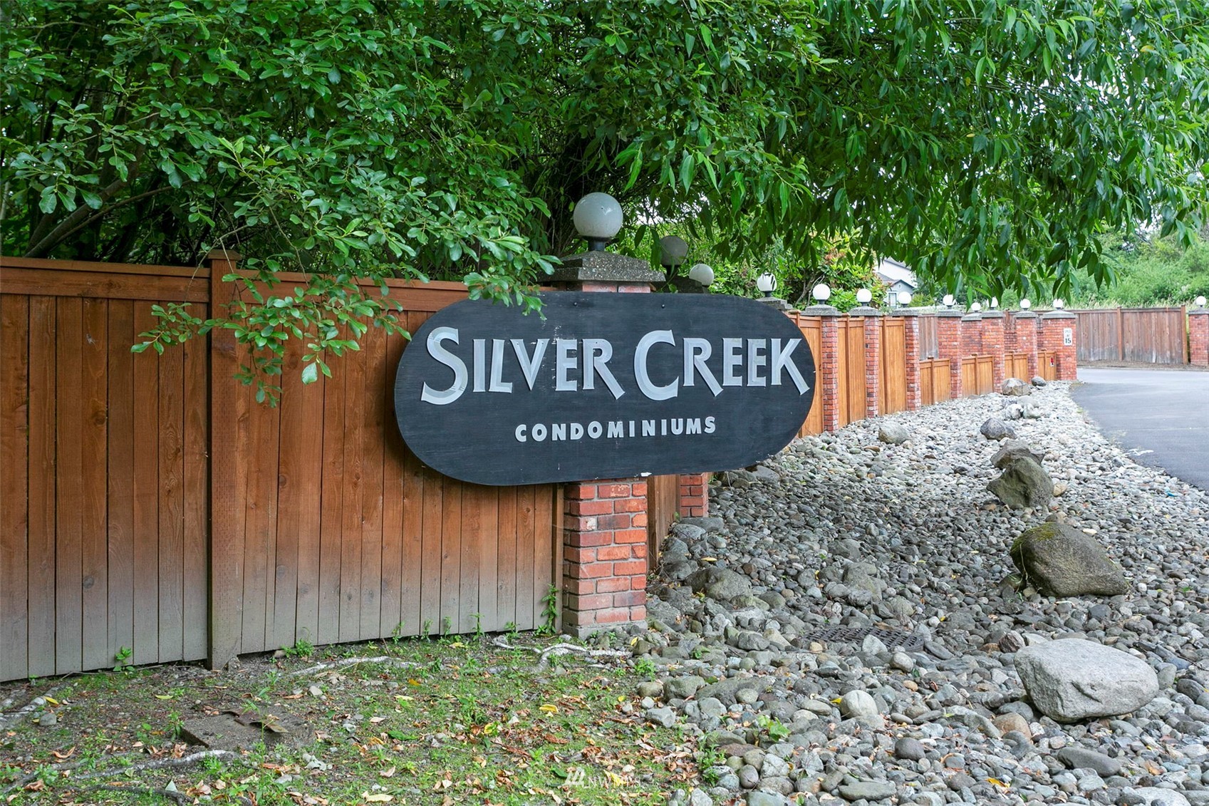 1806 201st Place Southeast, Unit 1D Bothell, WA 98012 - Photo 1 of 20 a view of outdoor space with signage and flags