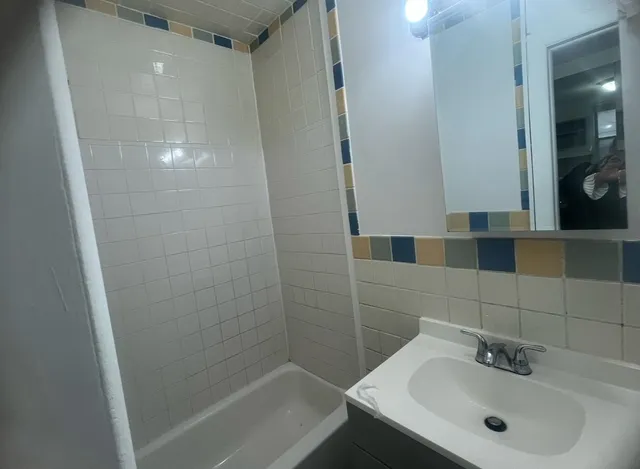 a bathroom with a sink mirror vanity and toilet