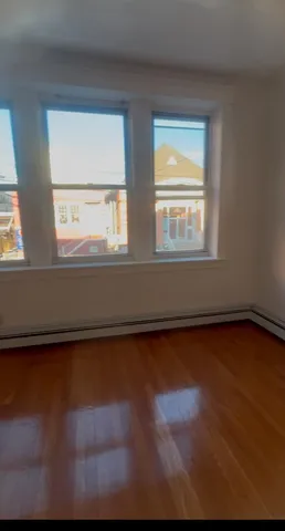an empty room with wooden floor