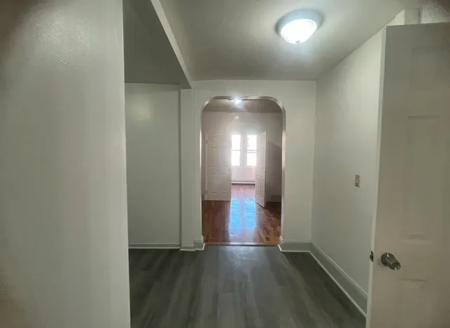 a view of a room with wooden floor