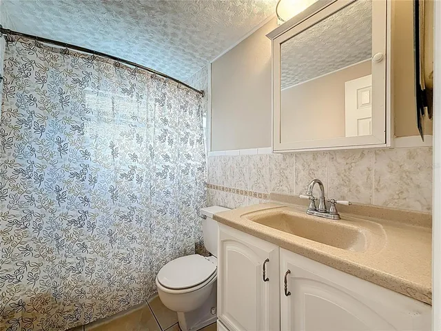 a kitchen with granite countertop cabinets stainless steel appliances and a sink