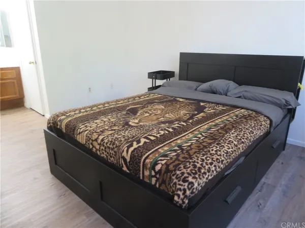 a bed sitting in a bedroom next to a window