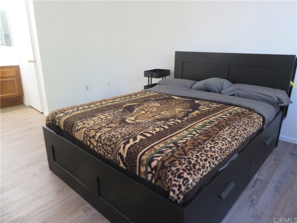 8167 Vineyard Avenue, Unit 66 Rancho Cucamonga, CA 91730 - Photo 13 of 16 a bed sitting in a bedroom next to a window