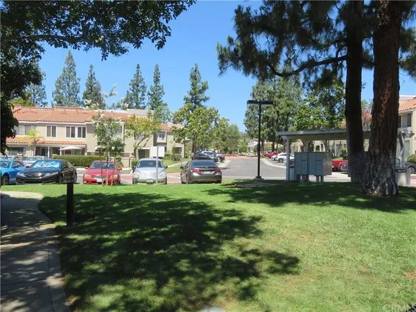 a view of yard with swimming pool and green space