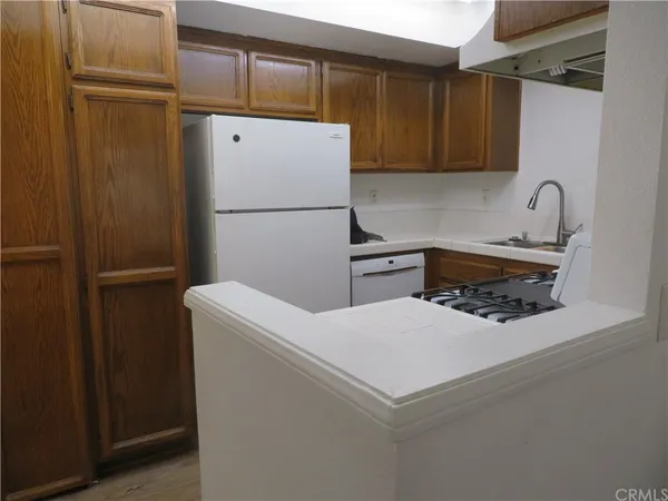 a kitchen with a refrigerator and a sink