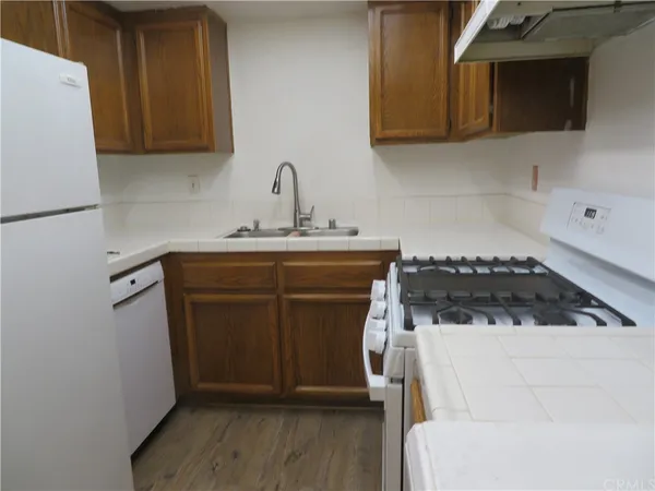 a kitchen with a sink a stove and a microwave