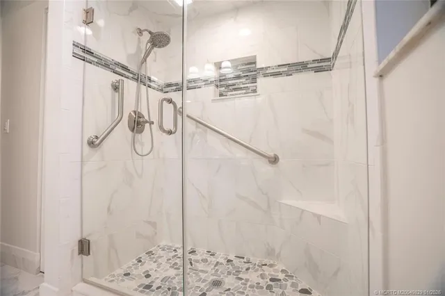 a bathroom with a shower and a shower head