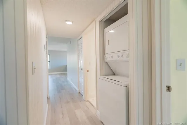 a view of a hallway with a door and closet