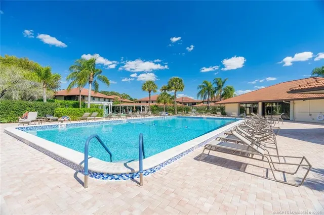 a swimming pool with outdoor seating and yard