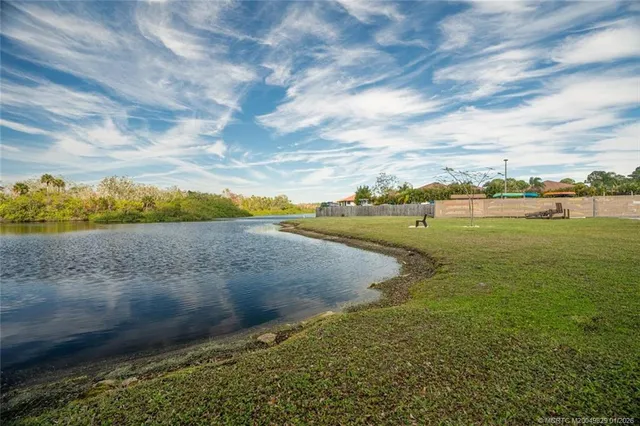 a view of a lake with houses in the back