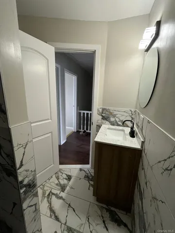 a bathroom with a sink toilet and mirror